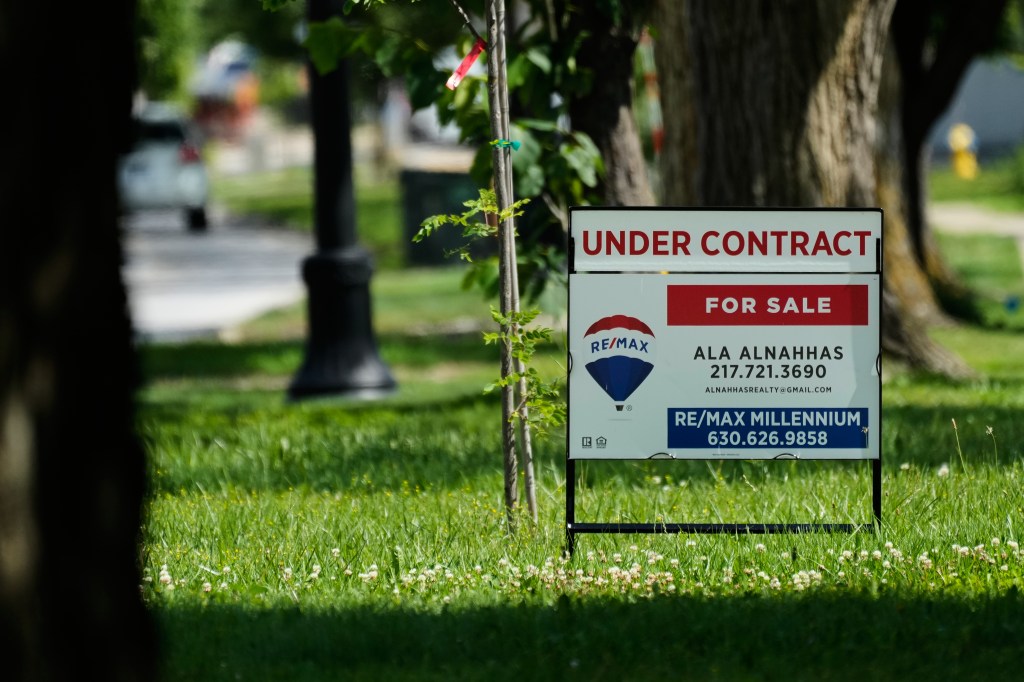 A "FOR SALE UNDER CONTRACT" sign for a home.