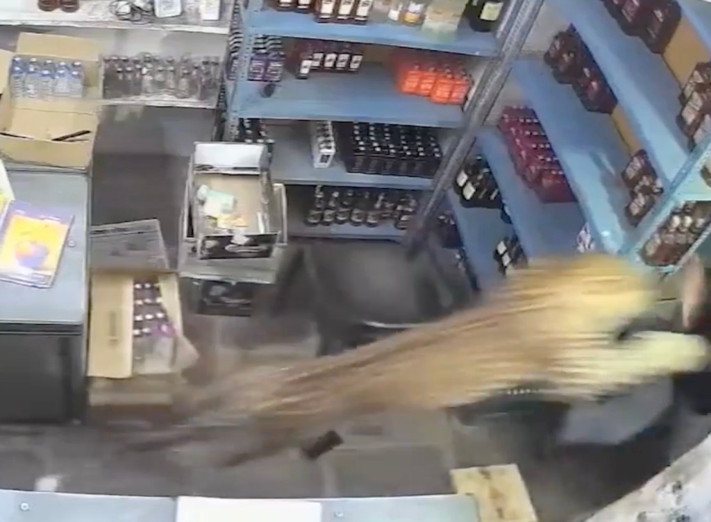 Leopard attacking a worker in a liquor store.