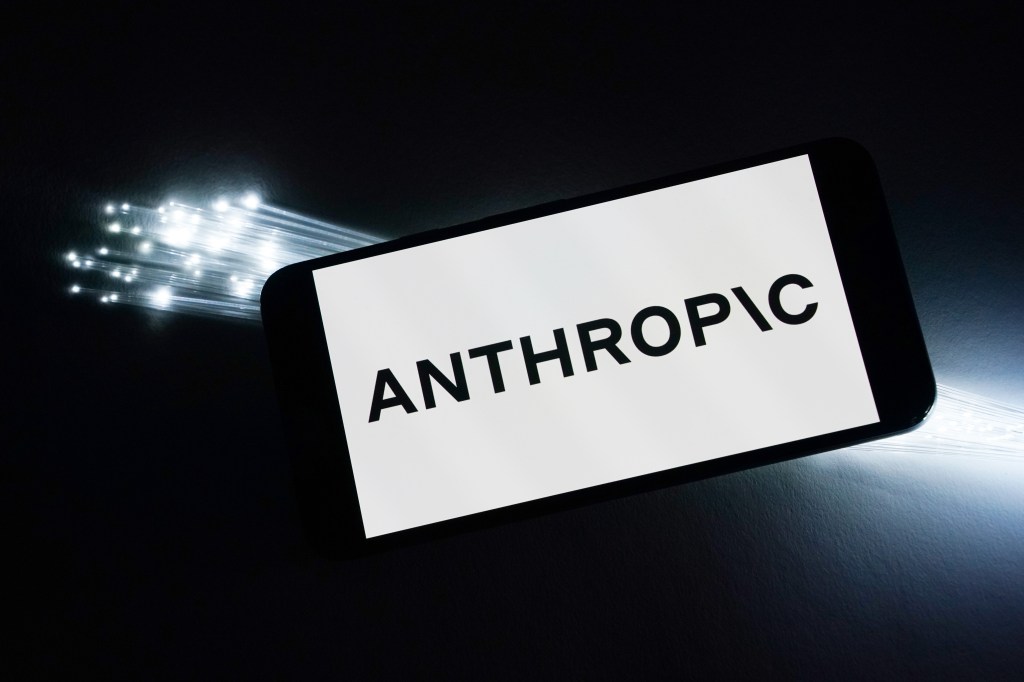 An Anthropic logo is displayed on a smartphone next to a keyboard or a printed circuit board in Hawthorne, NJ, on Friday, March 6, 2026.