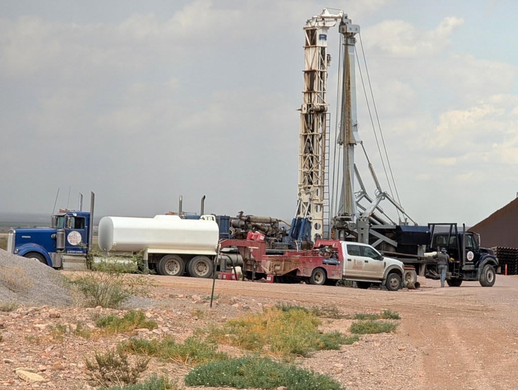 Construction crews drill wells for border wall construction.