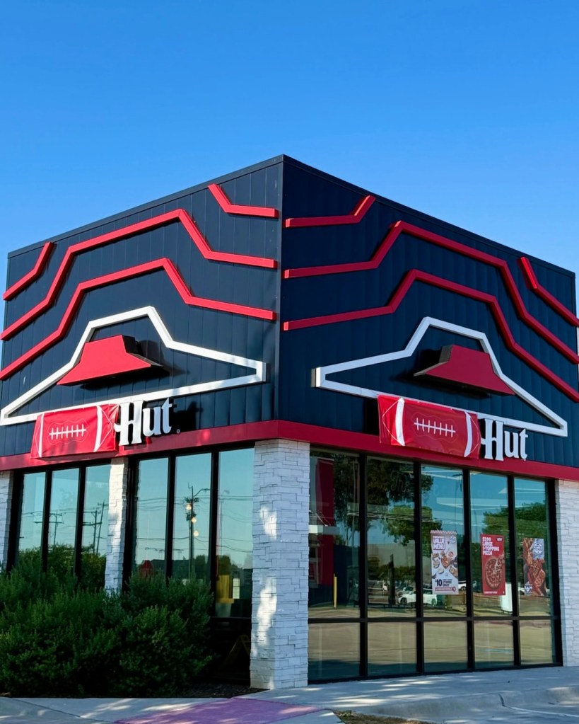 Pizza Hut building rebranded as "The Hut" for football season.