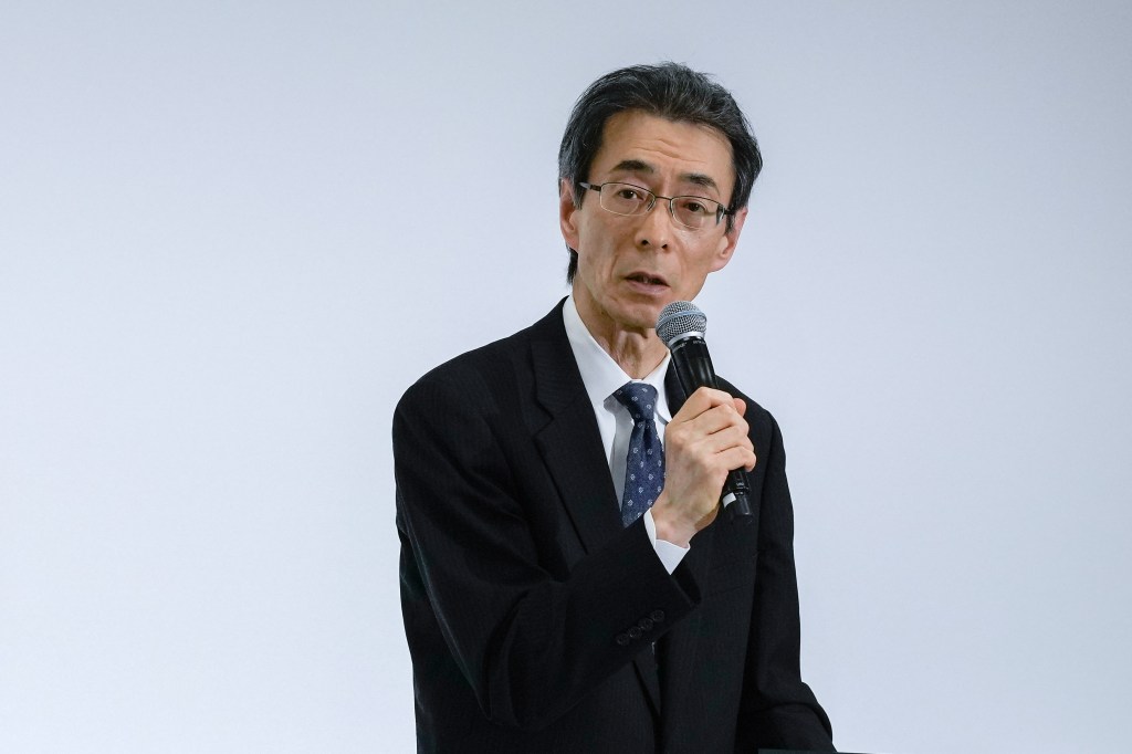 Noriya Kaihara, Executive Vice President of Honda Motor Co., speaks into a microphone at a news conference.