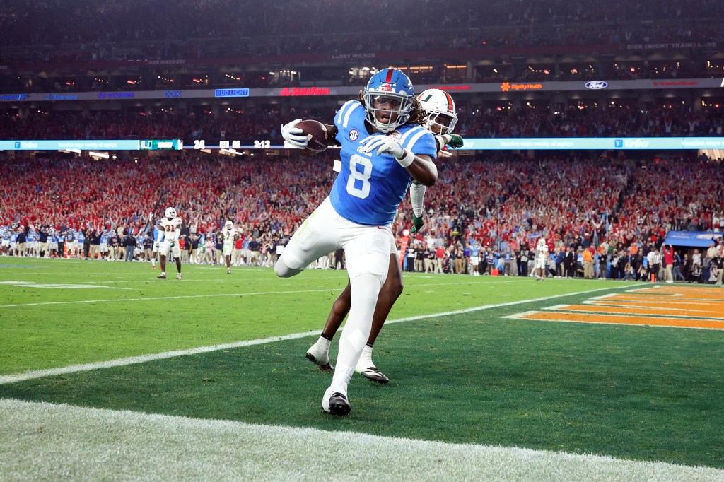Dae'quan Wright in a blue jersey with number 8, catches a pass for a touchdown.