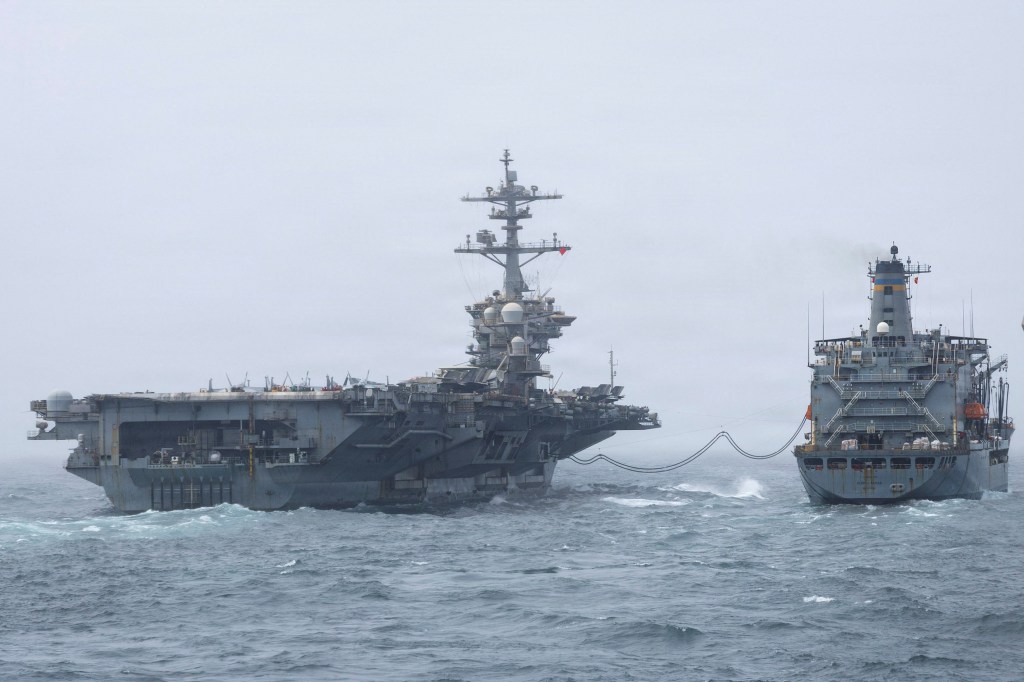 The USS Abraham Lincoln aircraft carrier refueling with the USNS Henry J. Kaiser at sea.
