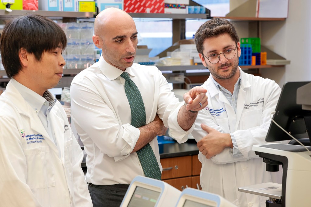 Dr. Kenji Mikki, Dr. Kalil Abdullah, and Dr. Maged Ghoche collaborating in a lab.