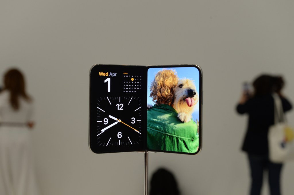 The iPhone Duo, Apple's first foldable smartphone, on display at a product launch event.