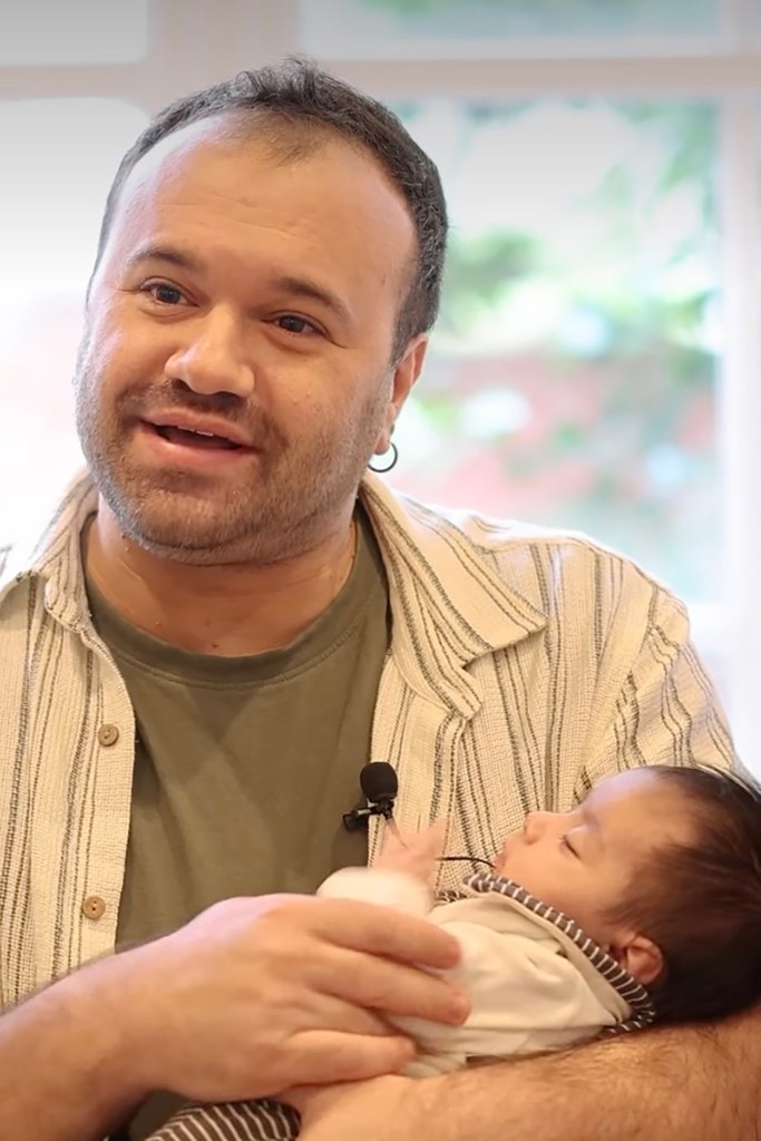 Adam Braitberg holds his daughter, Gali, as she sleeps.