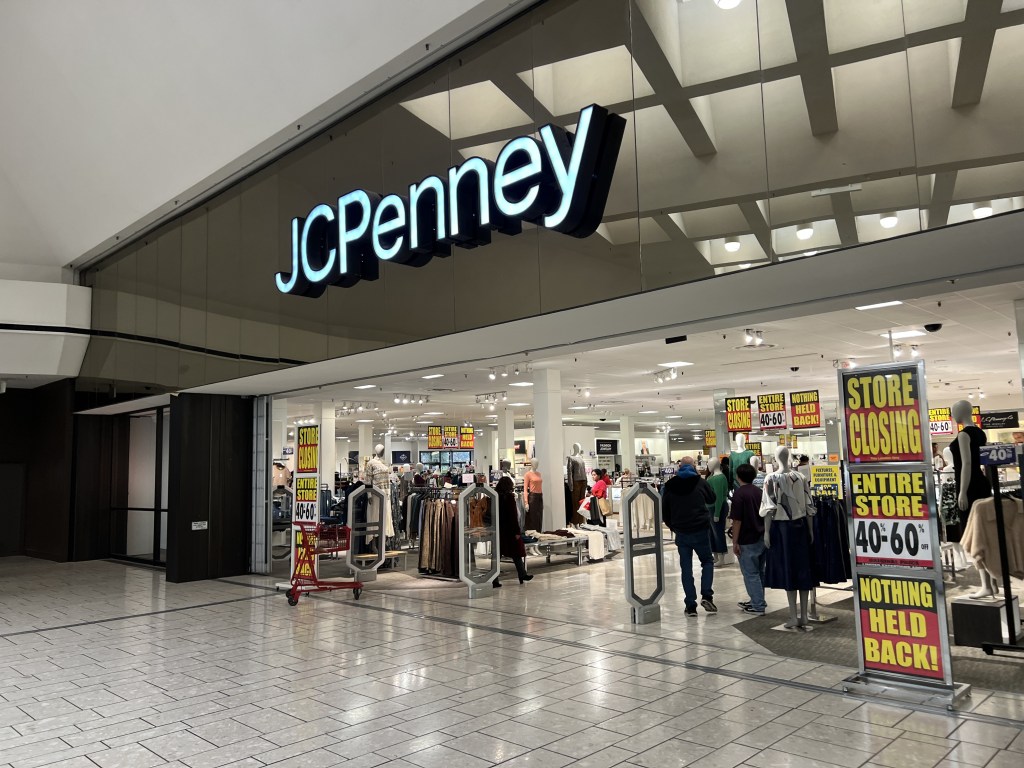 A JCPenney store with "STORE CLOSING" signs in its windows, advertising 40-60% off everything.