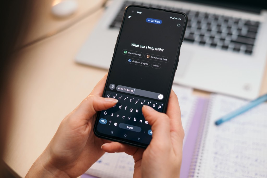 Person typing "how to get to" into an AI chat app on a smartphone.