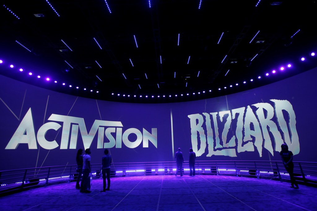 The Activision Blizzard booth at the Electronic Entertainment Expo, with large "Activision" and "Blizzard" logos illuminated in white and purple light.