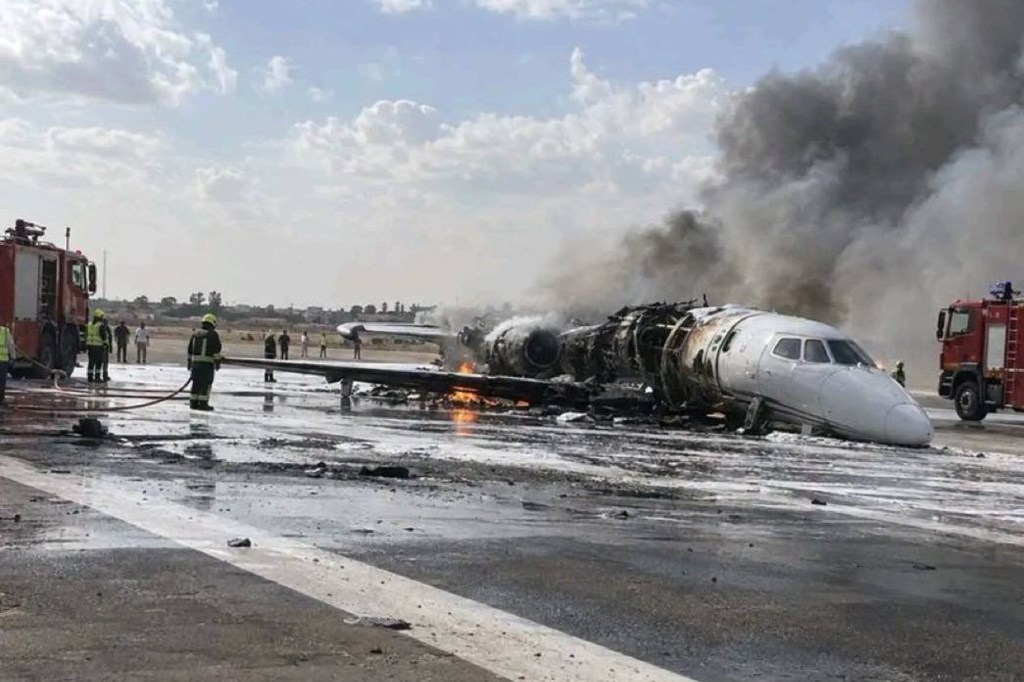 Emergency services extinguish the flames on a private jet at Misrata International Airport in Libya on Monday, Sept. 14.