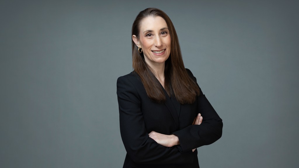 Dr. Susan Zweig, an endocrinologist specializing in bone health, smiling with her arms crossed.