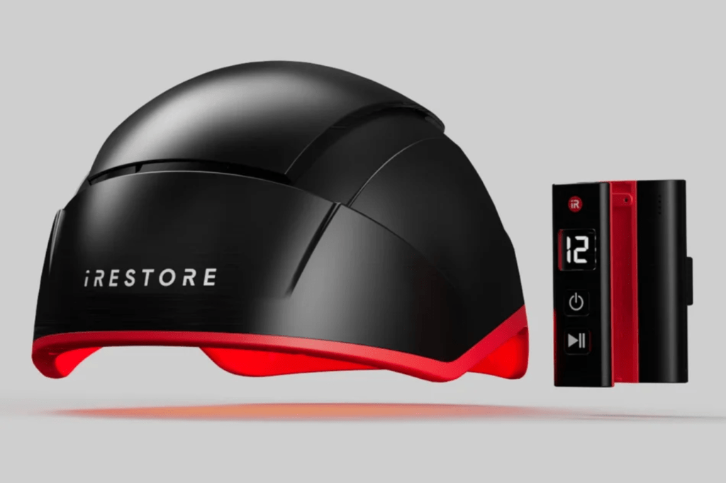 Illustration of a black and red iRestore laser hair restoration device next to its controller.