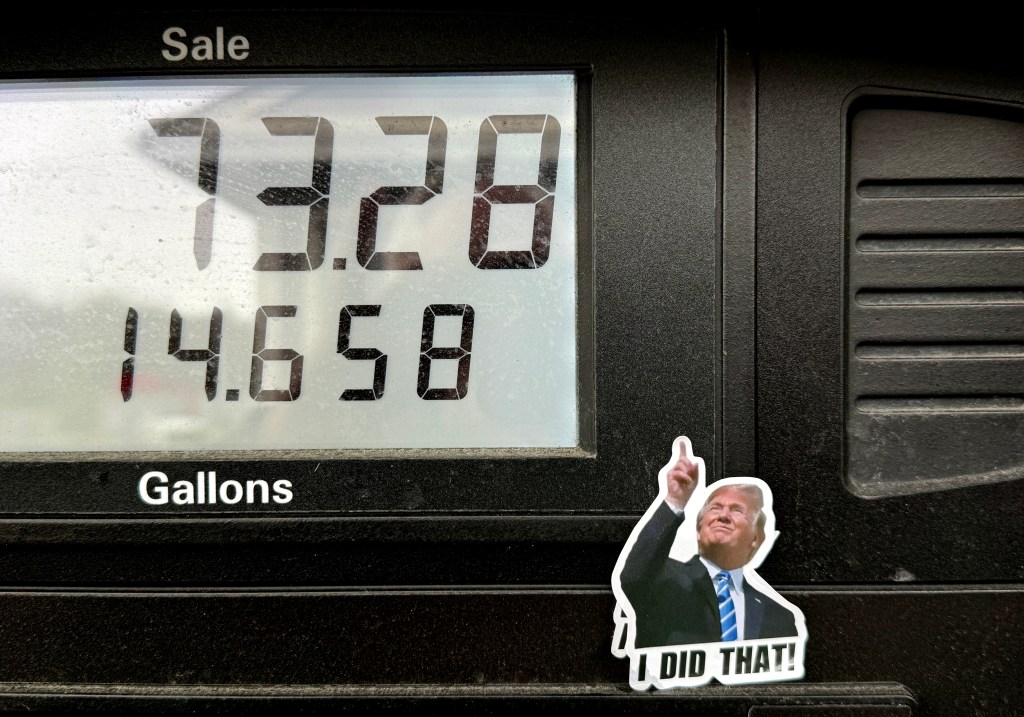 A sticker of Donald Trump pointing to the high gas price of $73.28 for 14.658 gallons.