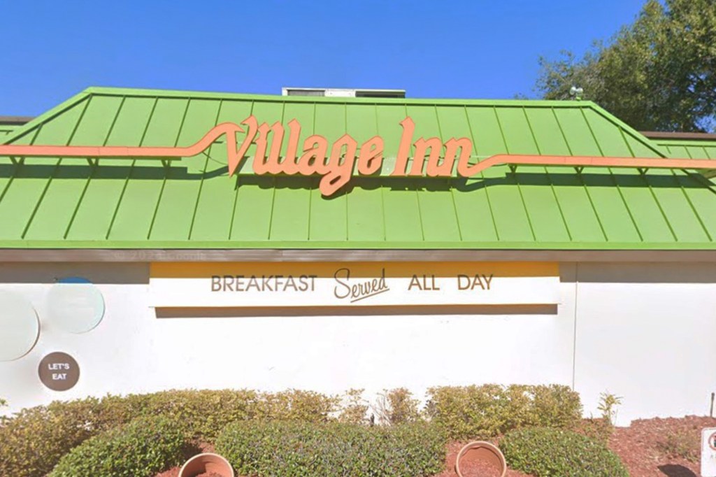 Village Inn restaurant exterior with green roof and "Breakfast Served All Day" sign.