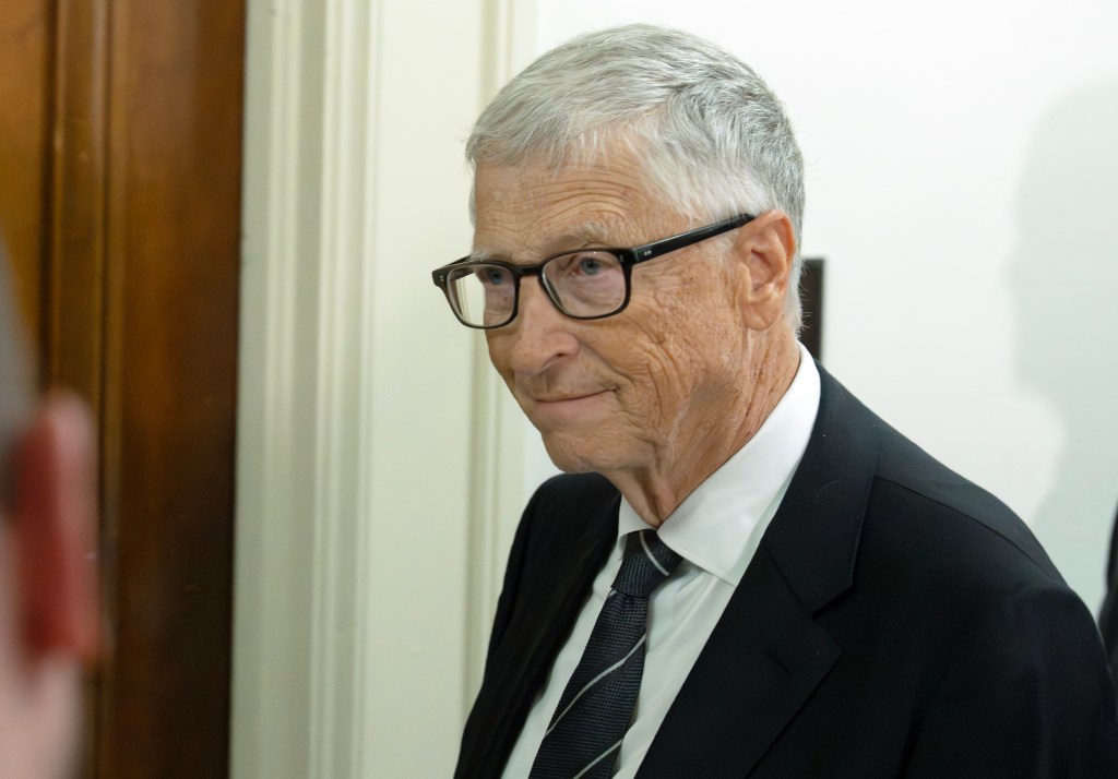 Bill Gates in a suit and glasses departs following his testimony before the US House Committee on Oversight and Government Reform.