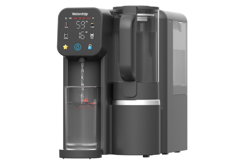 Waterdrop M6CG water filtration system dispensing water into a glass.