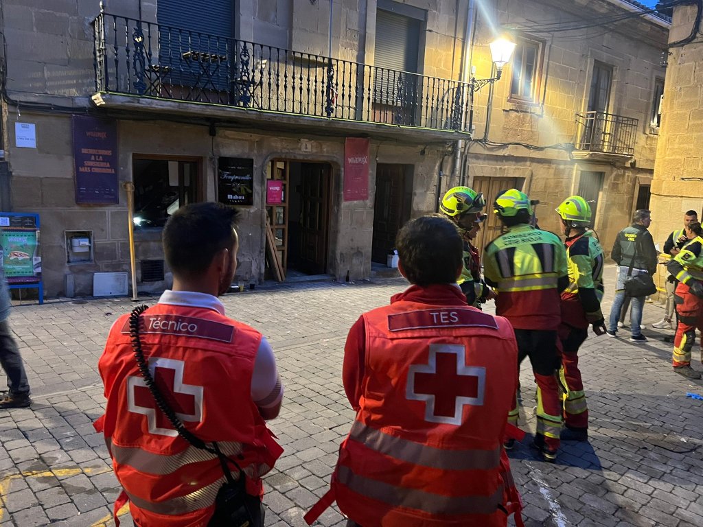 Emergency responders and Red Cross personnel gathered outside a building in northern Spain after a bar collapse.