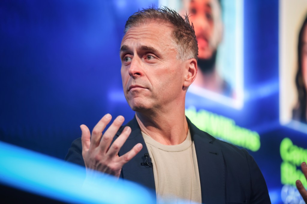 A speaker at the Bloomberg Power Players New York Summit gesturing with his hand while talking.