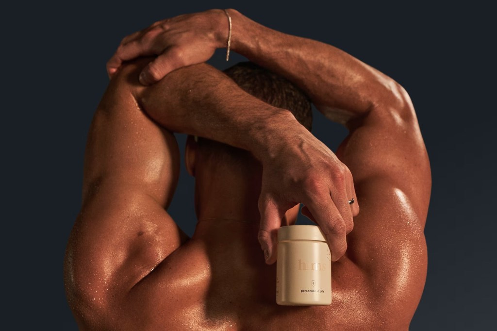 photo of a man holding a pill bottle from hims