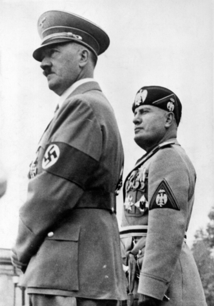 Benito Mussolini and Adolf Hitler attending a parade.