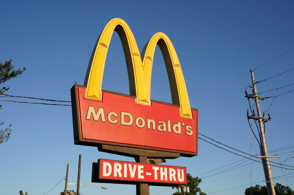 A McDonald's restaurant sign against a blue sky in Bayonne, New Jersey.