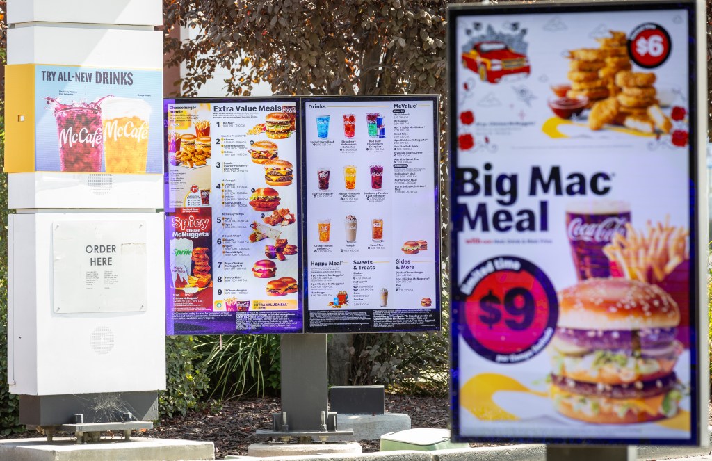 McDonald's drive-thru menu showing Extra Value Meals and a Big Mac Meal sign.