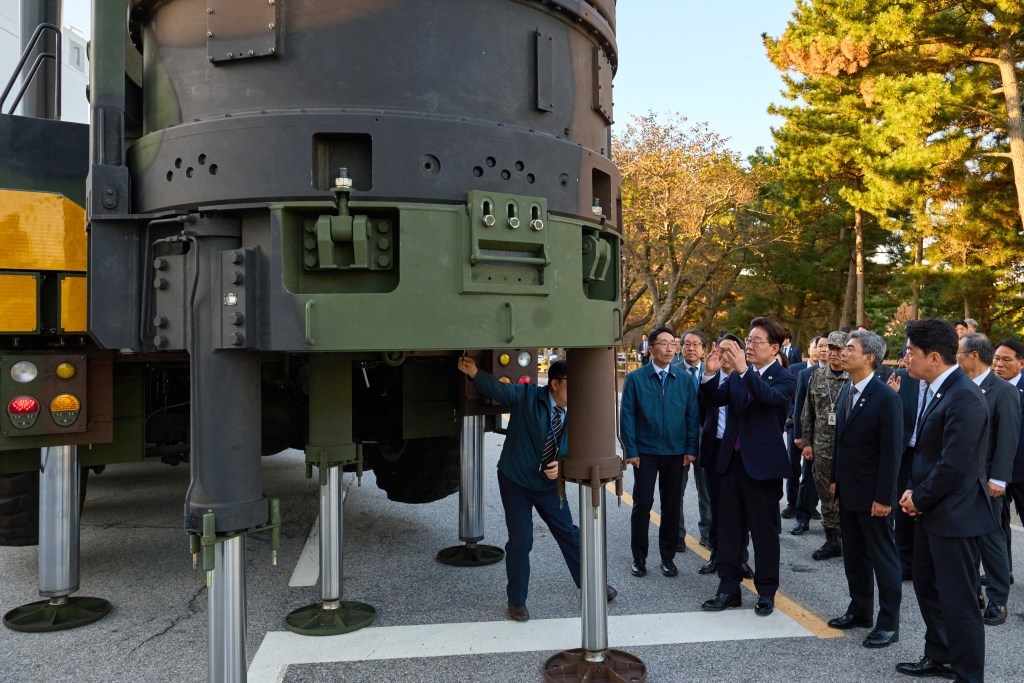South Korean President Lee Jae Myung looks at the Hyunmoo-5 missile at the Anheung Test Center of the Agency for Defense Development.