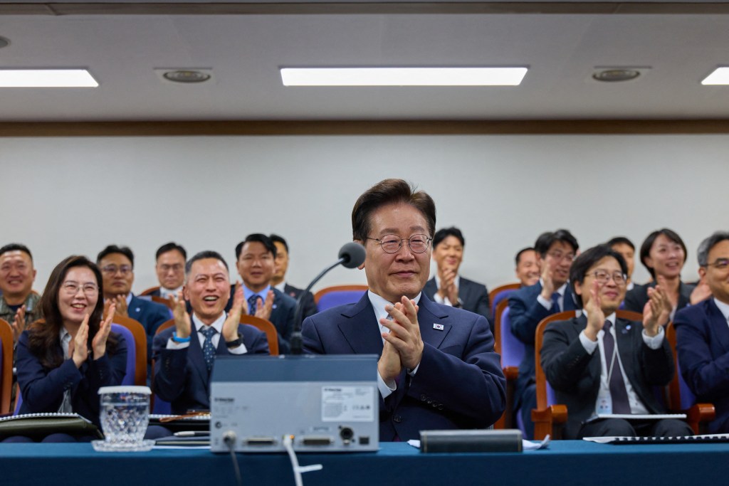 South Korean President Lee Jae Myung and other officials clap as they observe the first test launch of a hypersonic glide vehicle.