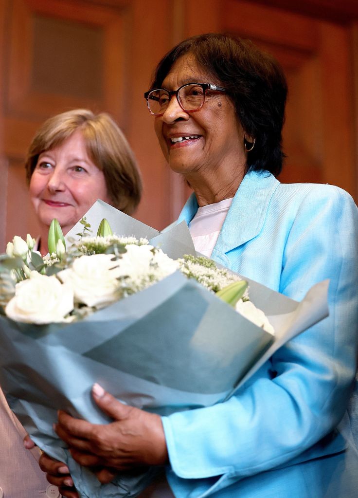 South African lawyer Navi Pillay holds flowers during a press conference.