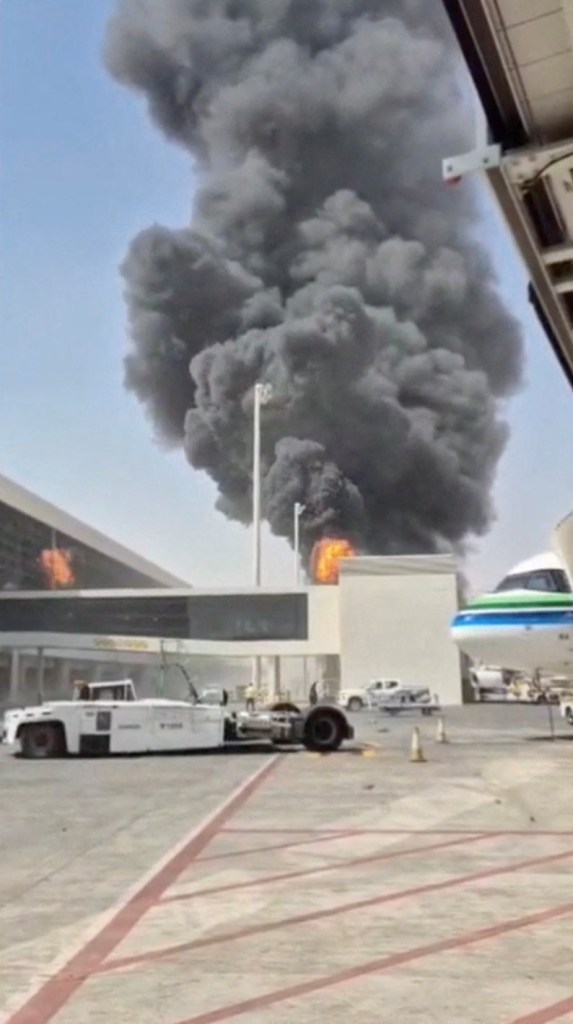 Thick black smoke and flames rise from King Khalid Airport in Riyadh, Saudi Arabia, following an attack.