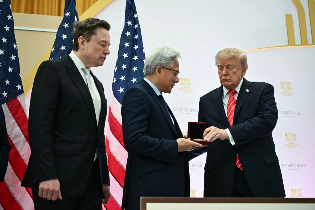 U.S. President Donald Trump presents the National Medal of Technology and Innovation to Nvidia CEO Jensen Huang, as Elon Musk looks on.
